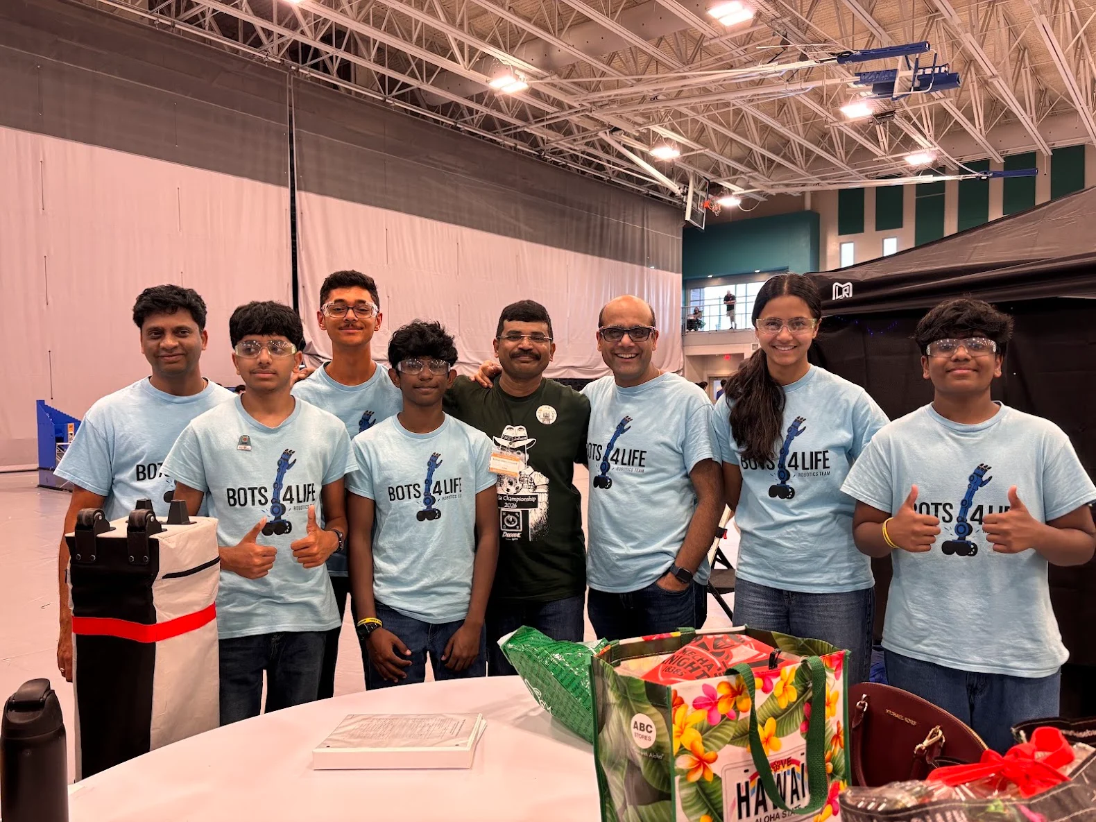 Mentors and youth building LEGO robots together